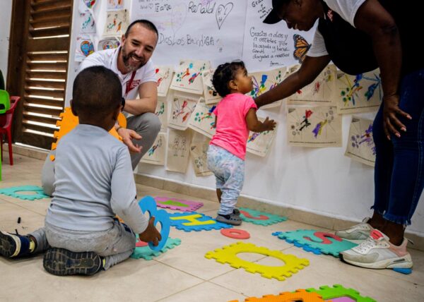 Elisander smiling at Jose in Colombia in the We Are Not Alone store for Venezuelan migrants