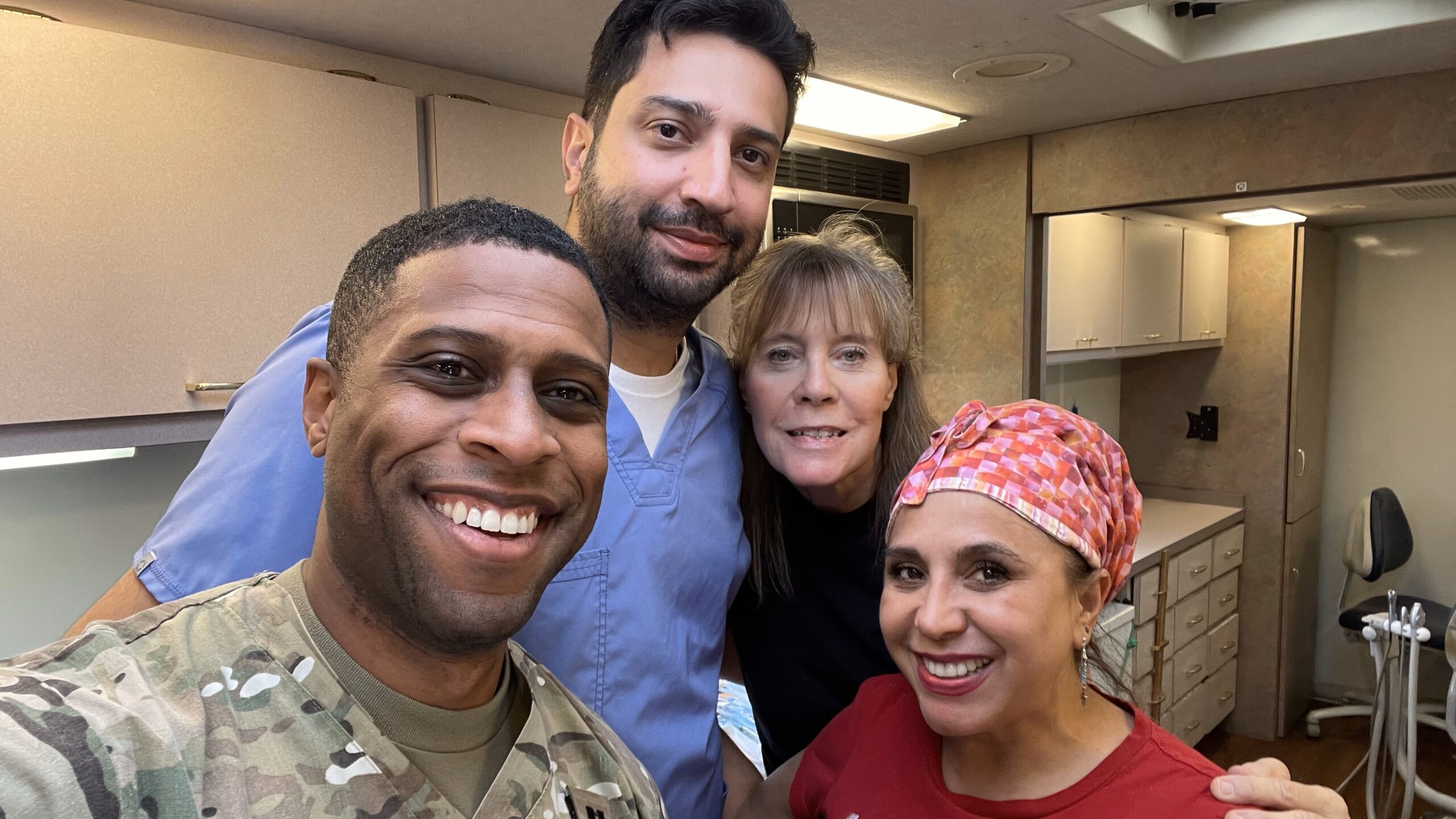 Dr. Lewis posing with other mobile dental clinic volunteers. 