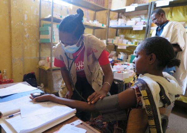 A Medical Teams health care worker checks the blood pressure of a patient in Ethiopia.