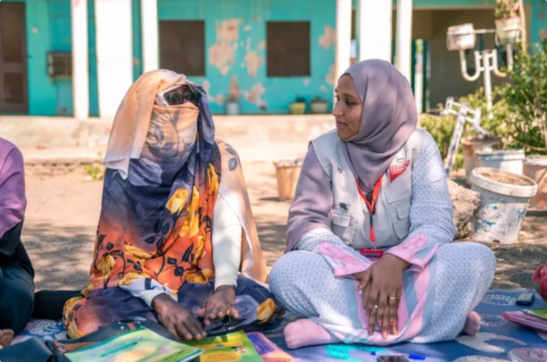 Salma Salah (right) meets with women across Sudan to help them educate and connect women to care. 
