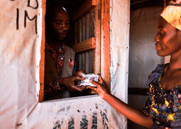 A woman named Sijaona collects medicines from the Medical Teams pharmacy.