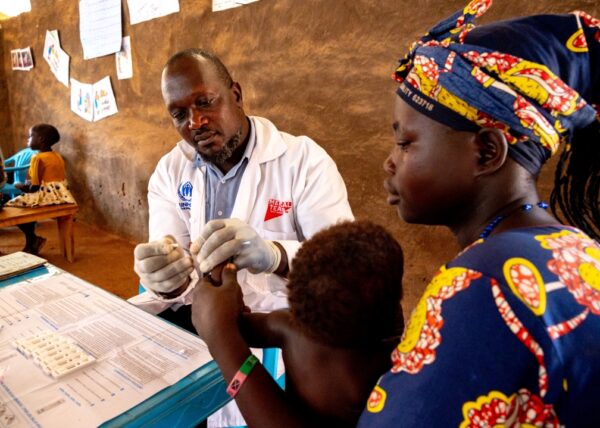 A child receives medical care from a Medical Teams health worker in Uganda.