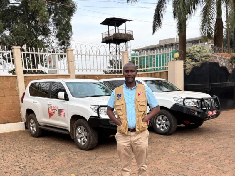 Grace standing in front of Medical Teams vehicles.