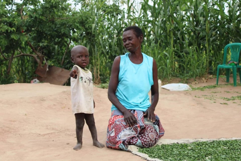 Ramsey playing while Betty works outside. 