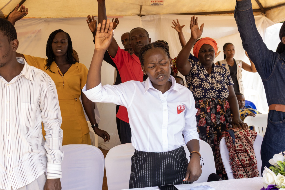 Uganda staff worshipping together. 