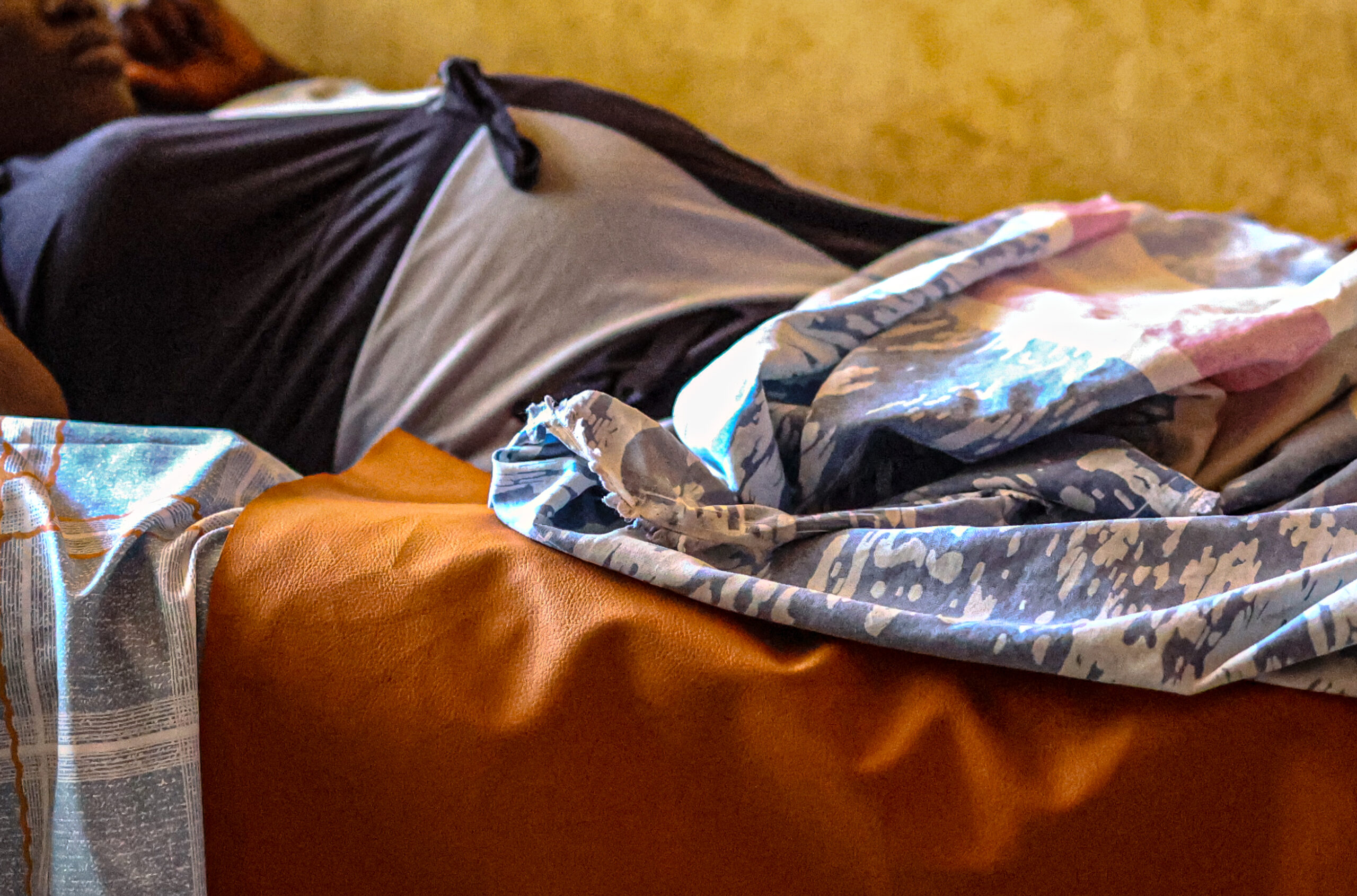 A young woman (not Selam) in labor awaits the birth of her child with the assistance of her own mother and Medical Teams staff in an Ethiopian clinic. 