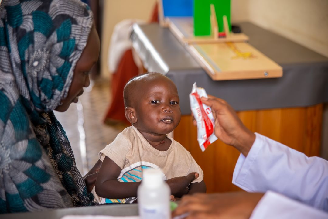 A boy named Ramadan receives nutritional food in Sudan.