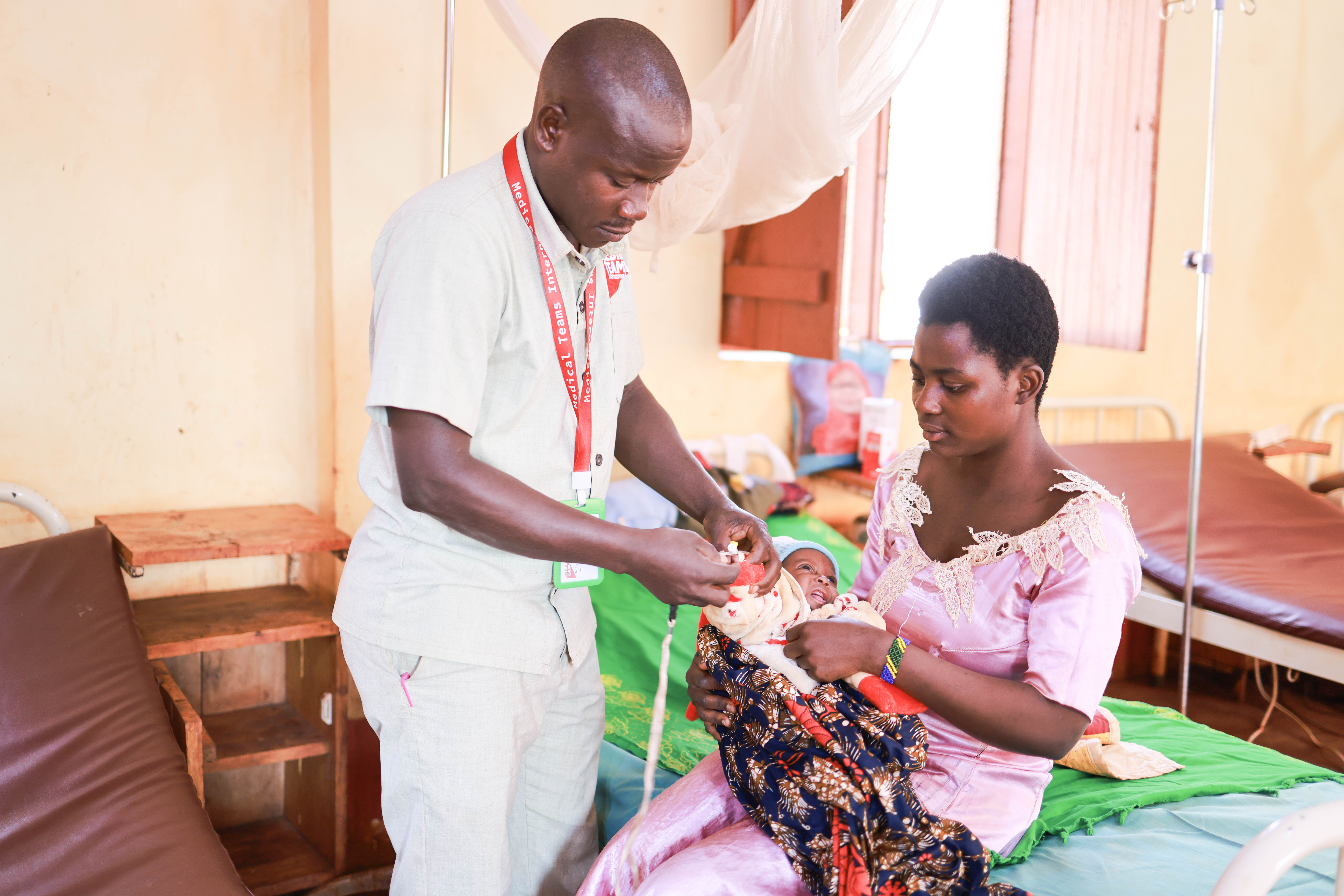 Anitha holding her son during consultation at a clinic in Tanzania. 