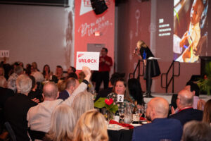 Bidder holds up bidding card