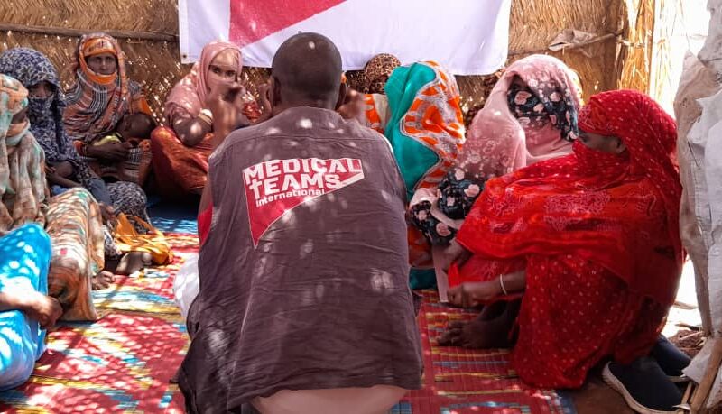 One of our MHPSS staff, Mansor, conducting a mental health support group for women in a Sudanese camp.