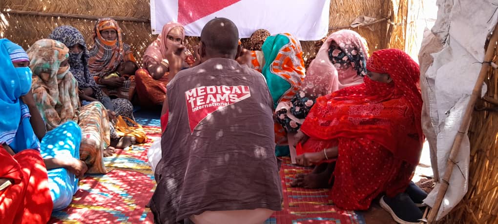 One of our MHPSS staff, Mansor, conducting a mental health support group for women in a Sudanese camp.