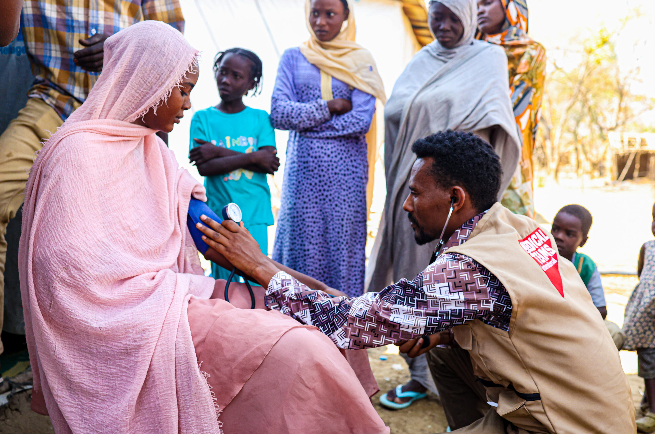 A family who recently arrived from Sudan receives treatment from Dr. Negash at the transit center just across the Ethiopian border.