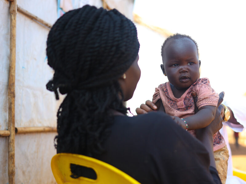 Kinana holding her youngest child.