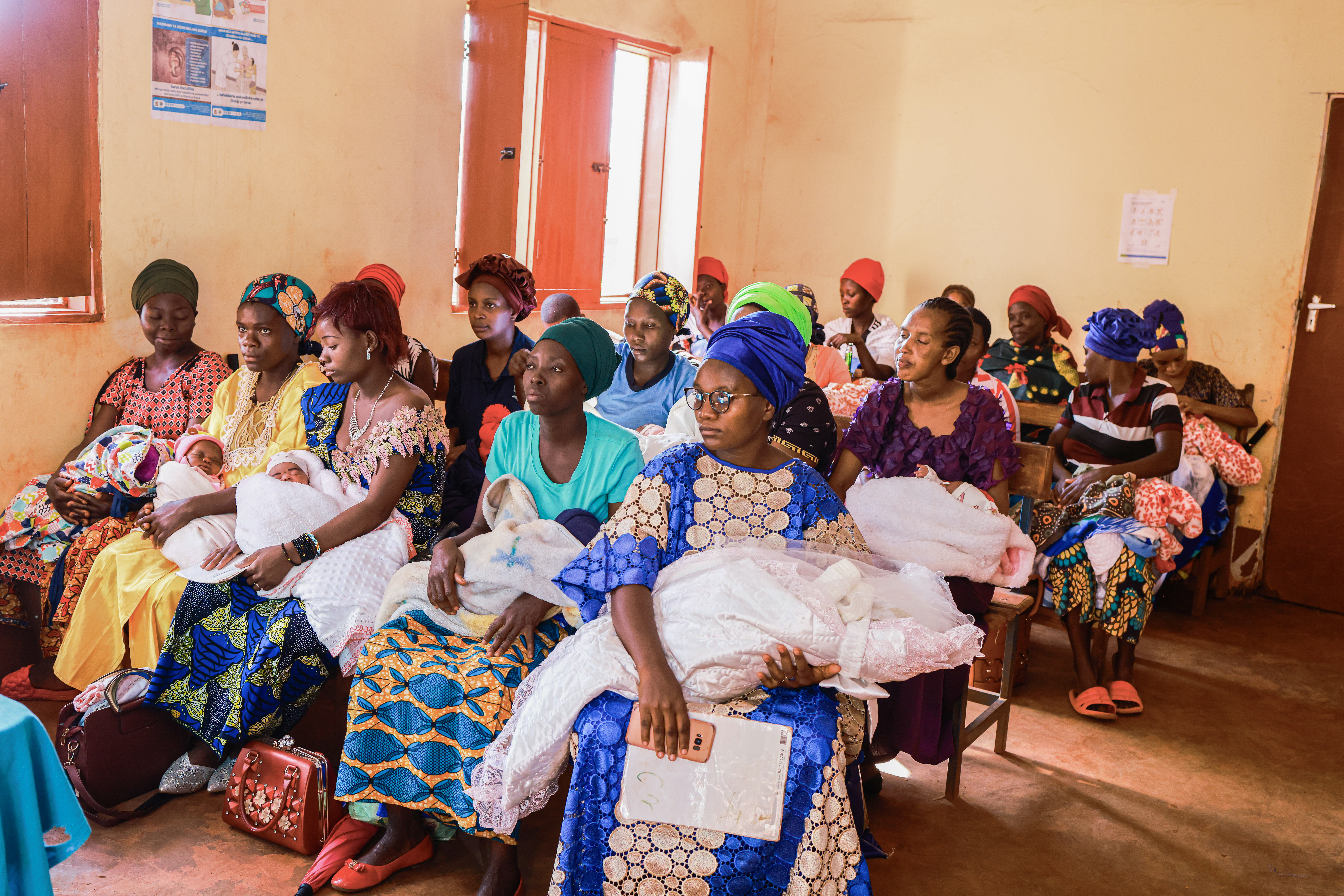 Mothers wait for care in the postnatal ward with their newborn babies at a clinic in Tanzania.