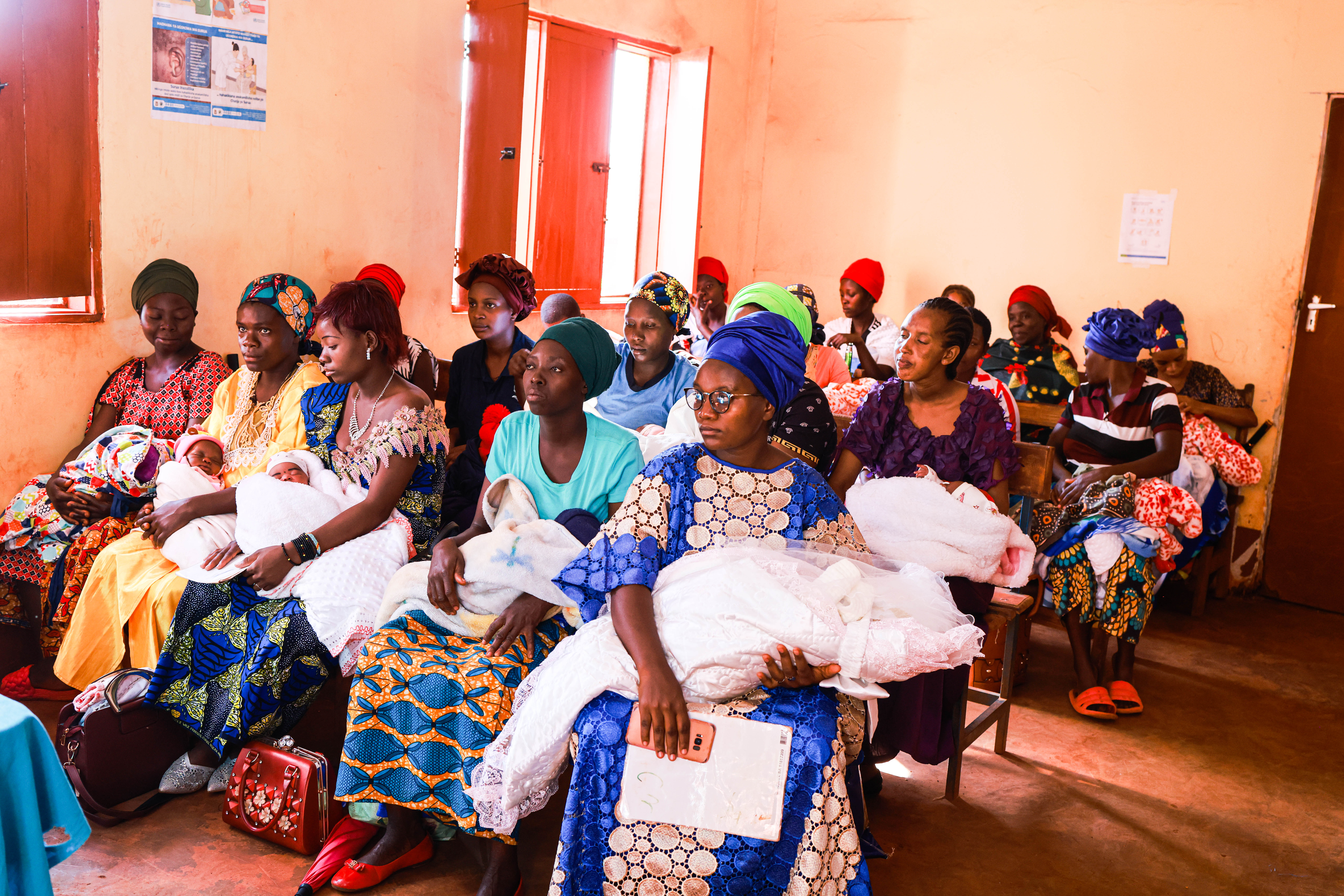 Mothers wait for care in the postnatal ward with their newborn babies at a clinic in Tanzania.