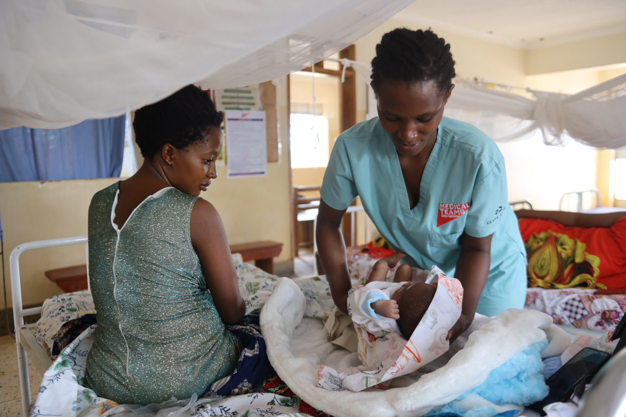Devota Tumusifu being supported by a midwife at Kasonga Health Center in Uganda