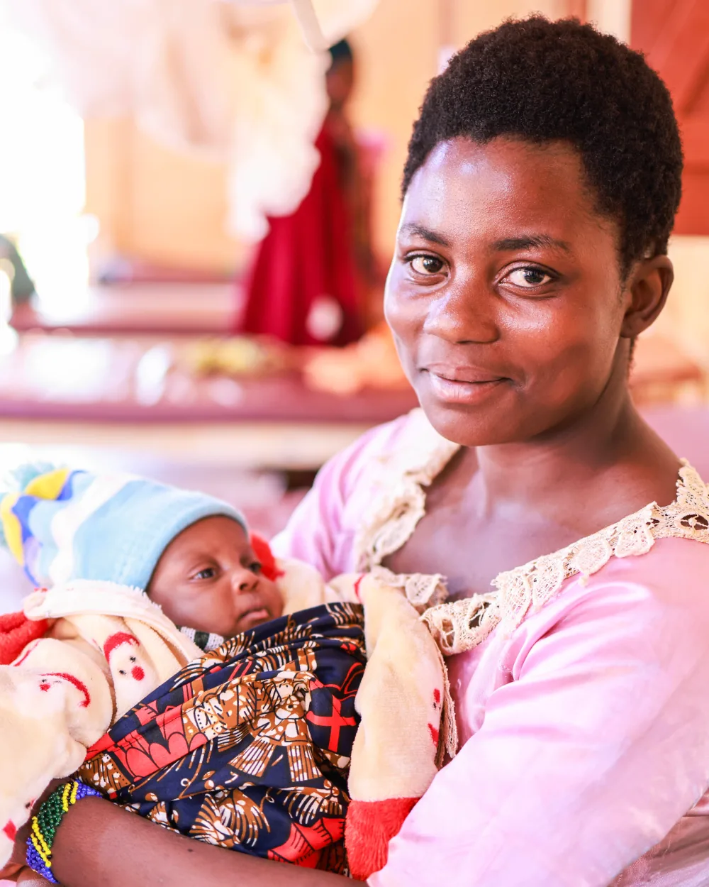 Anitha Uwineza holding her baby in Tanzania