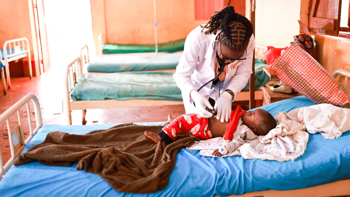 A Medical Teams health worker providing care to a child.