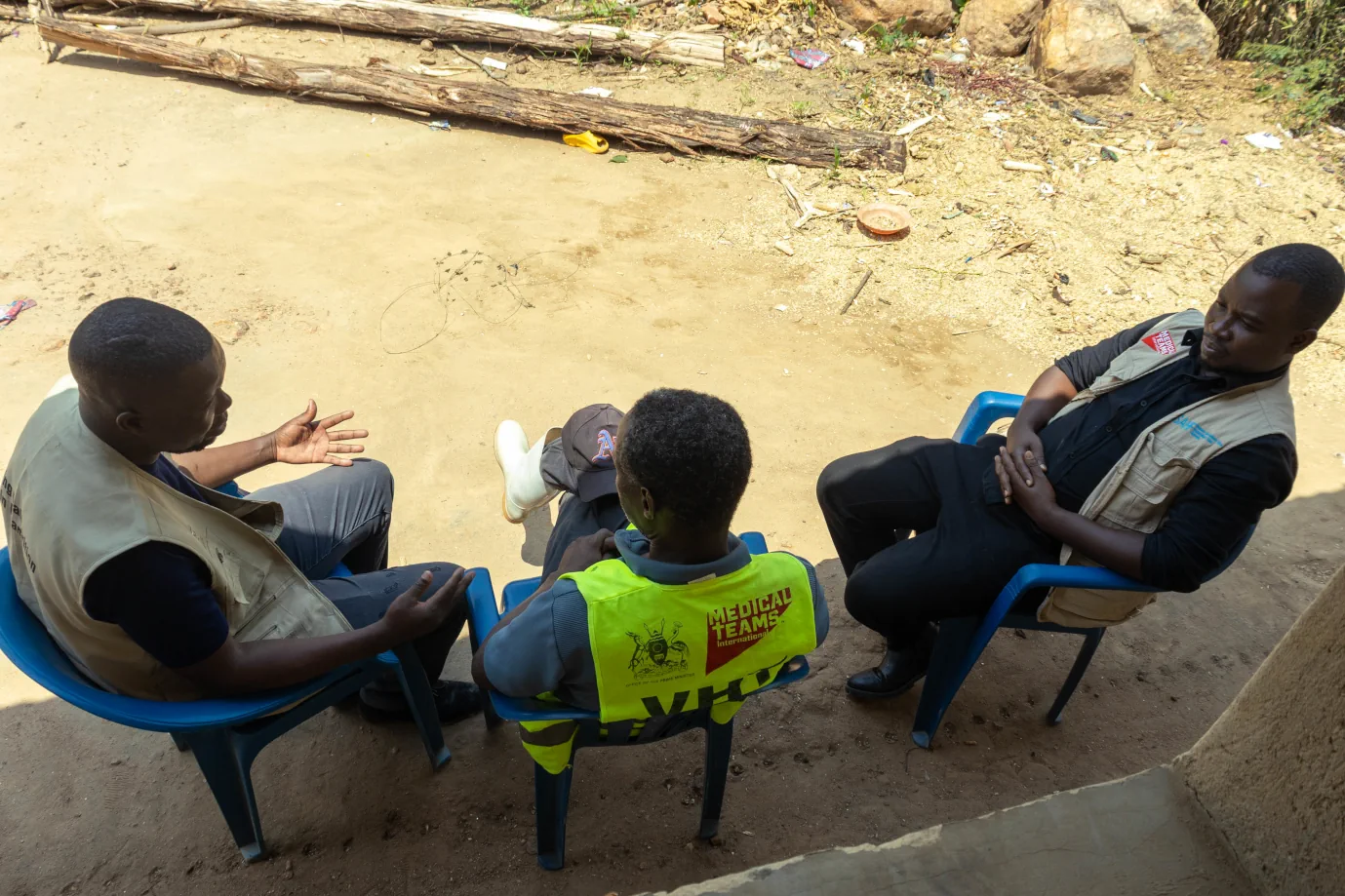 Medical Teams International staff meets with Faust Minane, VHT, Uganda, 2026