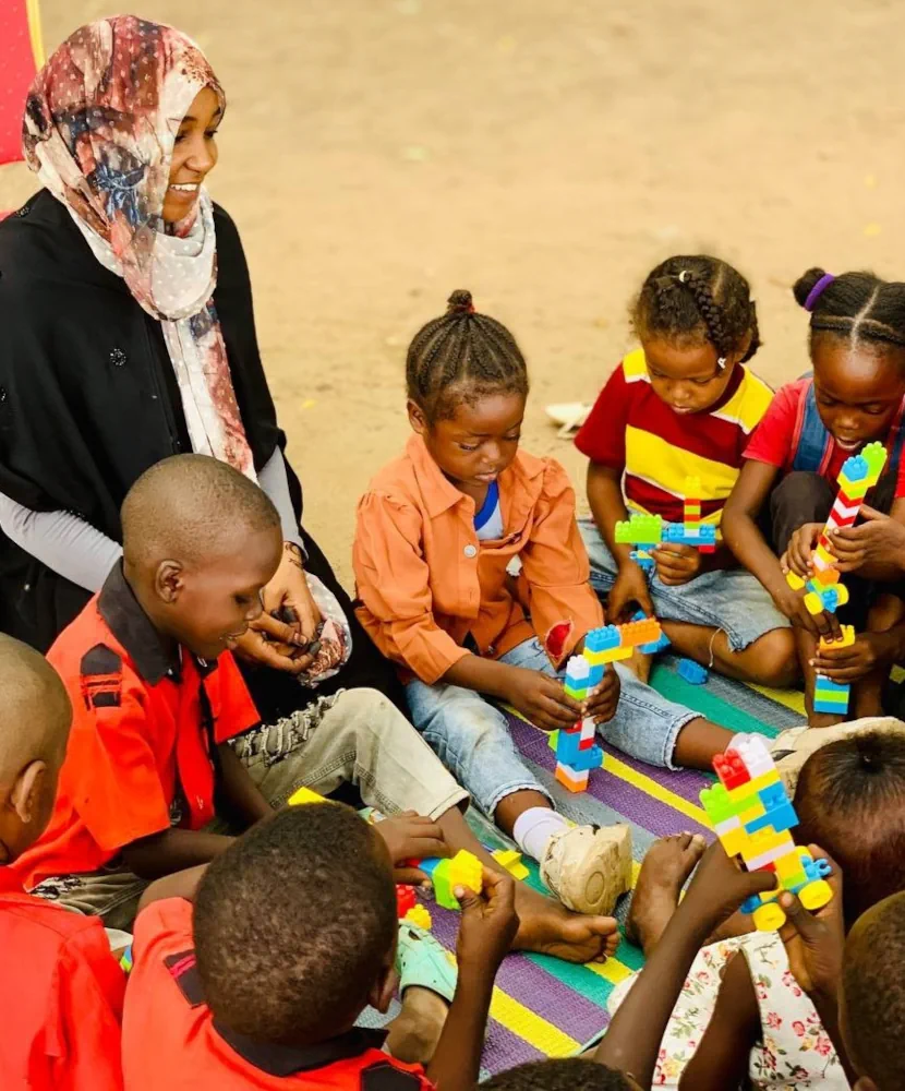 Asma and kids during a session in Sudan.